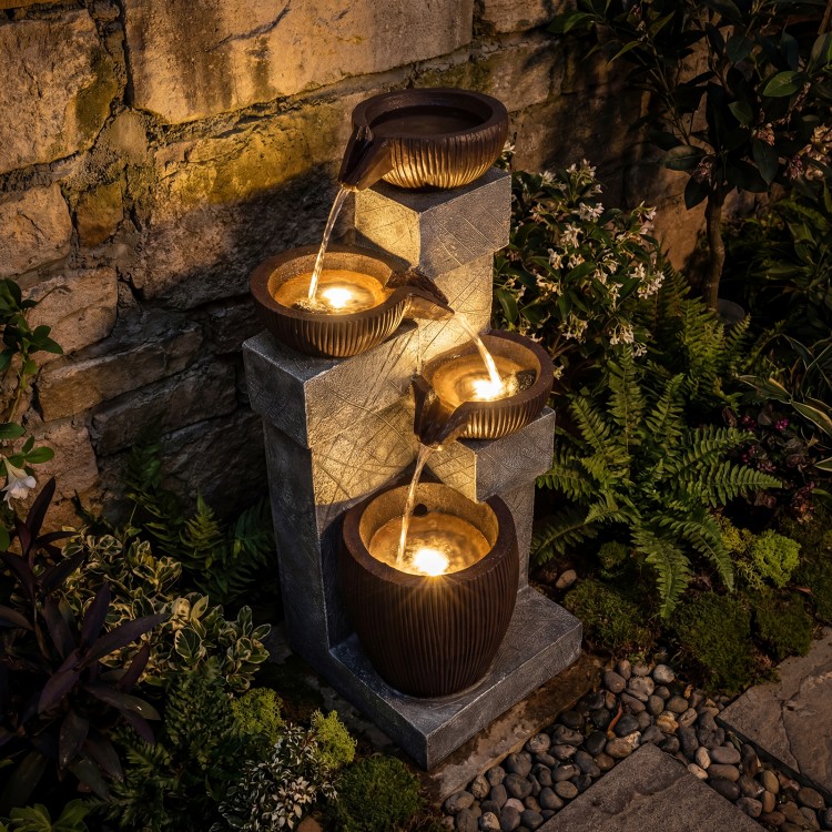 4-tier cascading bowl outdoor water fountain with LED lights, featuring realistic gray stone and rustic brown bowls for.