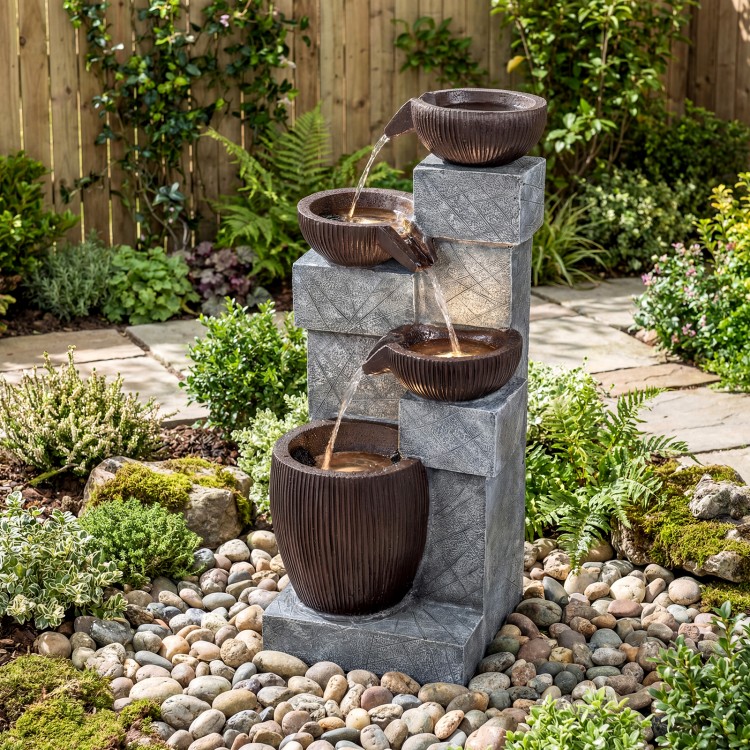 4-tier cascading bowl outdoor water fountain with LED lights, featuring rustic brown bowls and gray stone design for.
