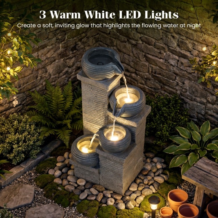 4-tier outdoor water fountain with LED lights, showcasing cascading bowls and a peaceful ambiance for relaxation.