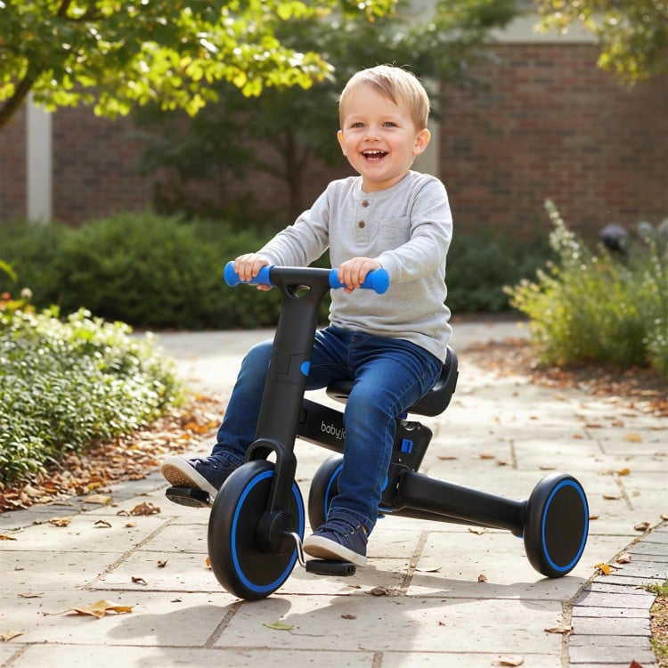 Toddler riding the 4-in-1 foldable tricycle with adjustable seat and push handle, perfect for outdoor fun and safety.
