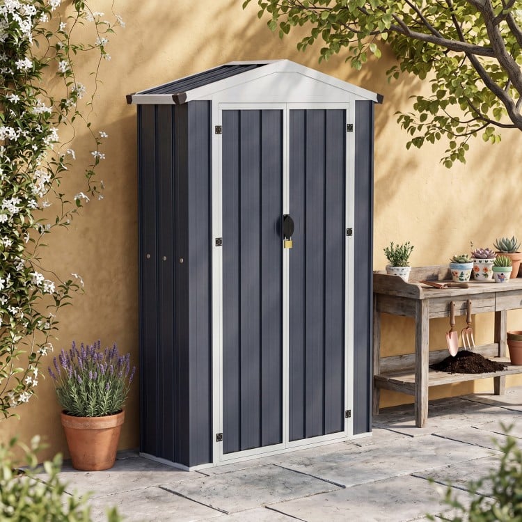 Outdoor storage shed with sloping roof, lockable door, and built-in shelf, perfect for organizing patio items.