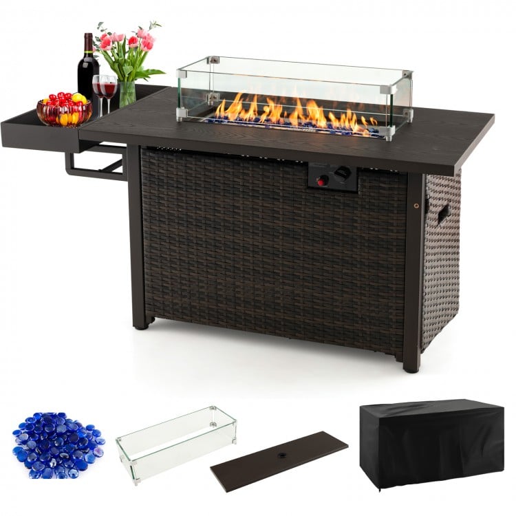 Outdoor wicker gas fire pit table with tempered glass wind guard, 50,000 BTU heat output, and waterproof cover.