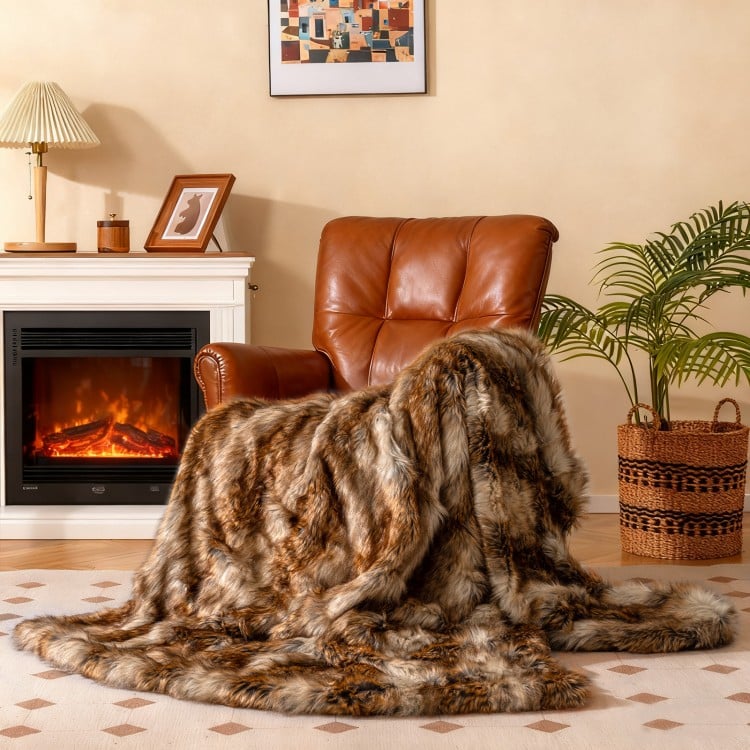 Luxurious 540GSM faux raccoon fur blanket draped over a chair, perfect for cozy warmth and stylish decor.