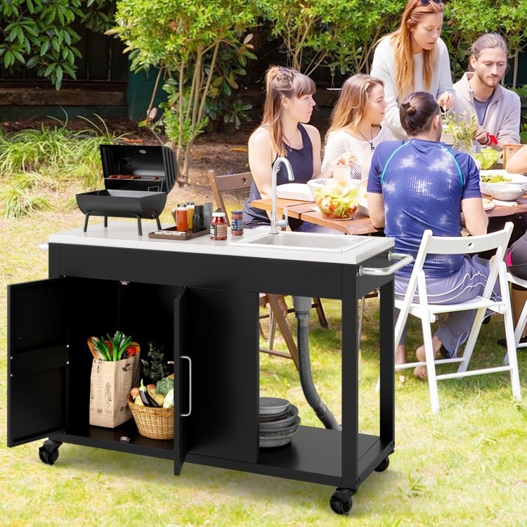 Outdoor grill table with stainless steel top, sink, and storage cabinet, perfect for backyard gatherings and easy.