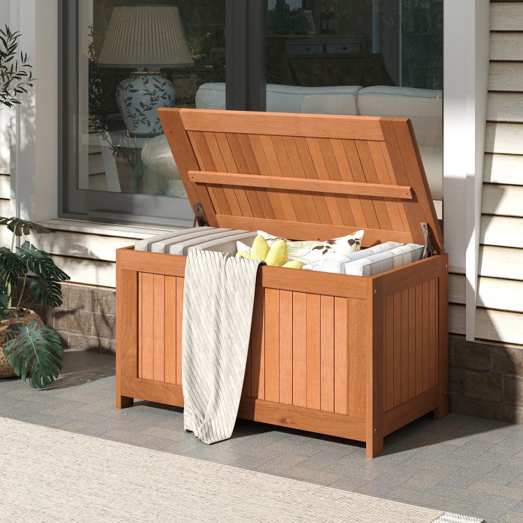 52-gallon patio wood deck box with flip top, ideal for cushions and outdoor storage, shown in a garden setting.