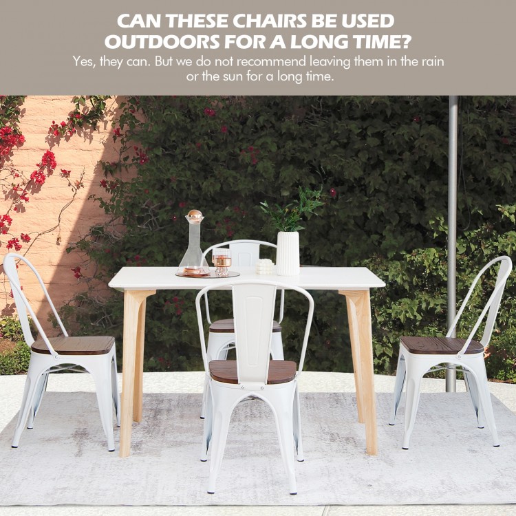 Set of 4 Tolix style metal dining chairs with wood seats in white, perfect for kitchen or dining room use.