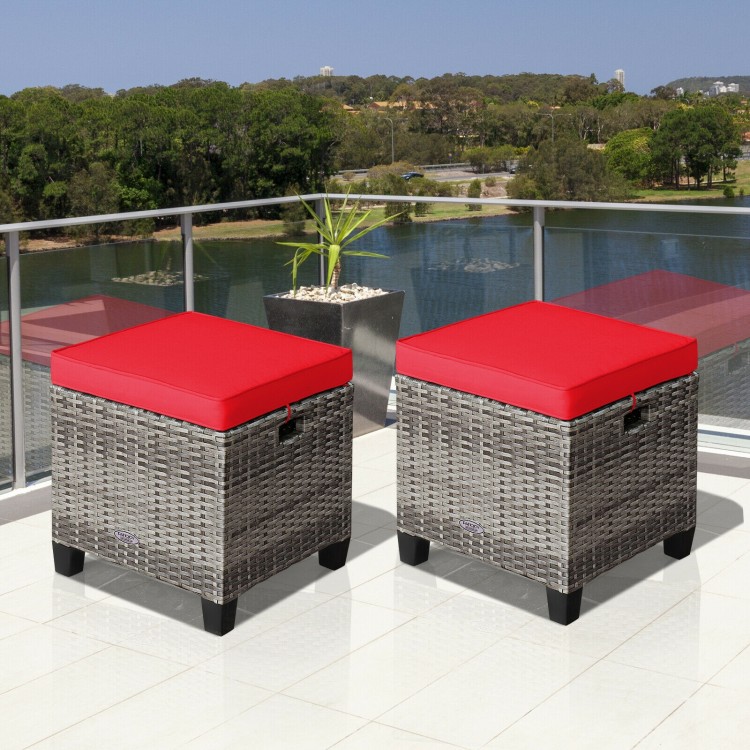 Two outdoor rattan ottomans with removable red cushions, perfect for patio and poolside relaxation.