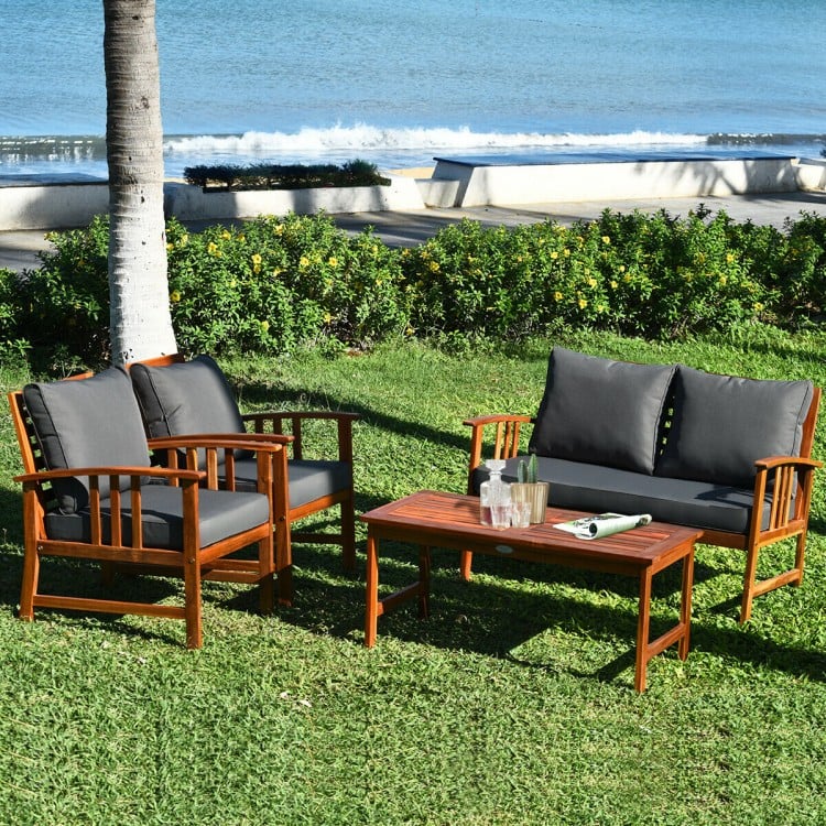 Wooden patio furniture set featuring a loveseat and two chairs with soft cushions, perfect for outdoor relaxation.