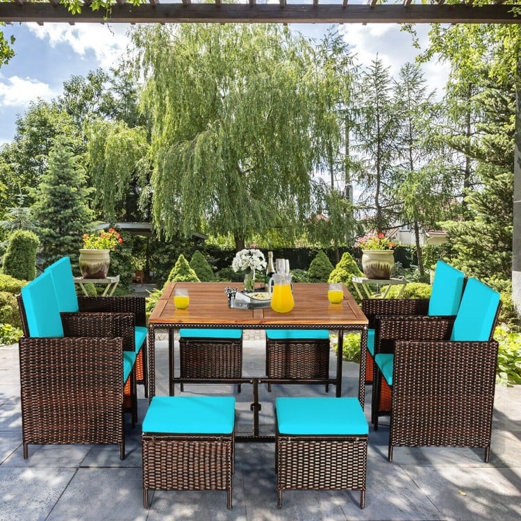 9-piece patio dining set featuring turquoise cushioned chairs and acacia wood tabletop, perfect for outdoor gatherings.