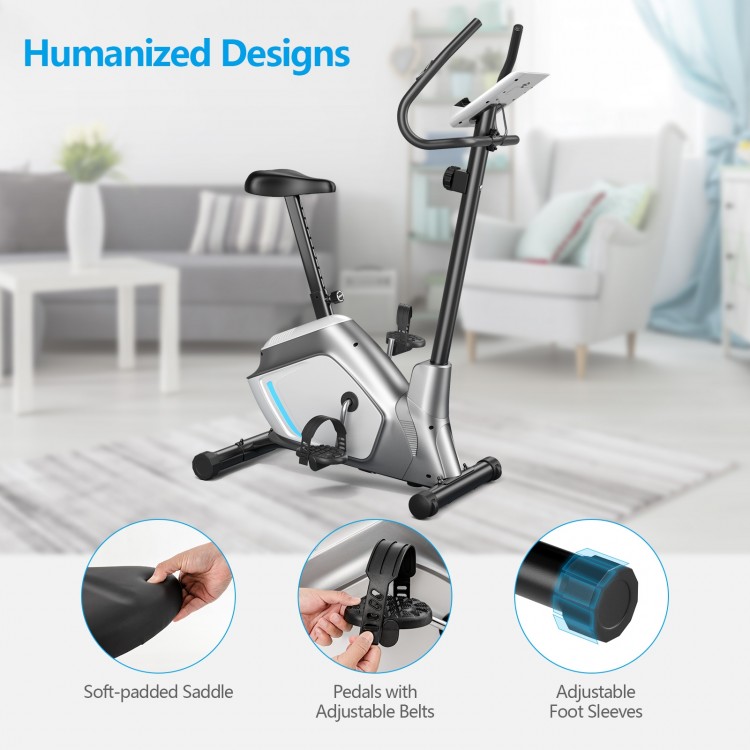 Magnetic exercise bike with adjustable seat, LCD monitor, and pedals with adjustable belts for home workouts.