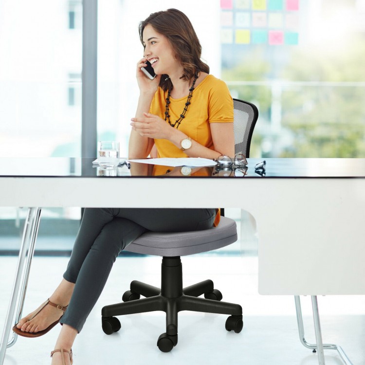 Gray armless computer chair with detachable cushion cover and smooth wheels, perfect for mobile office environments.