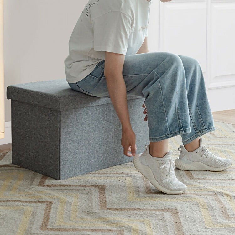 Light gray 30-inch folding storage ottoman with lift top, featuring soft fabric and spacious interior for versatile.