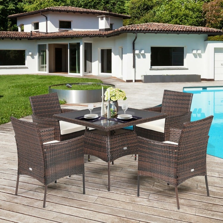 Outdoor 5-piece dining table set featuring a sturdy steel frame, PE rattan, and soft cushions, perfect for patio.