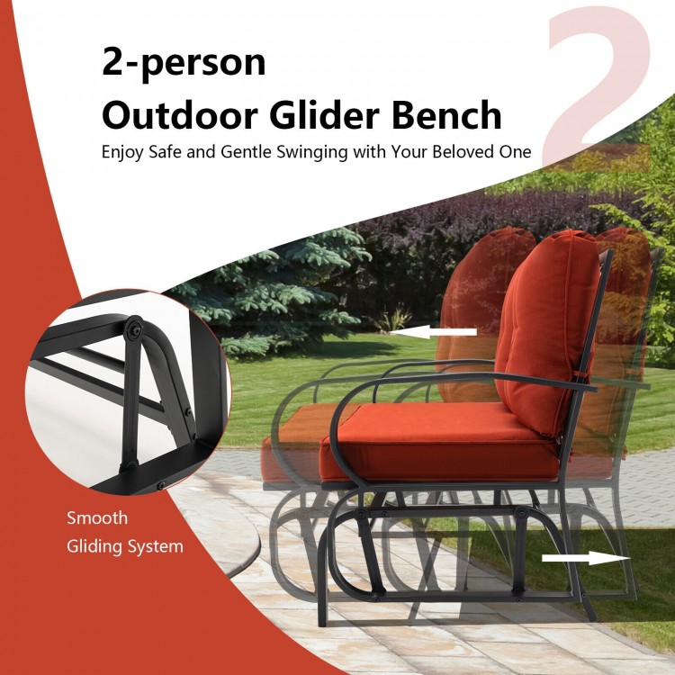 2-person outdoor glider bench in brick red with cushioned armrests, perfect for patio relaxation and gentle swinging.