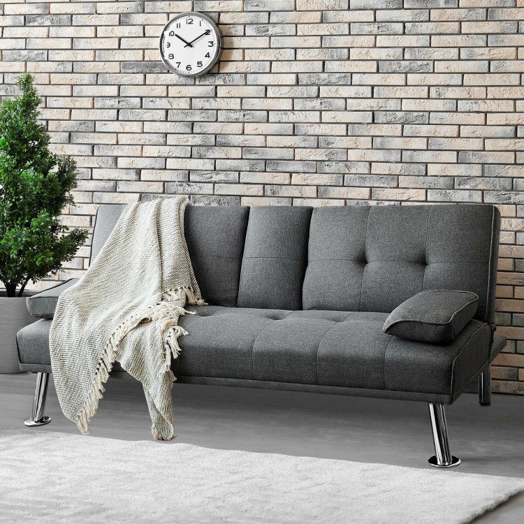 Convertible dark gray futon sofa bed with removable armrest and cup holders, perfect for apartments and compact spaces.