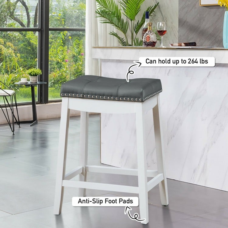 Nailhead saddle bar stool with soft upholstery, rubber wood legs, and anti-slip foot pads, ideal for kitchens and bars.