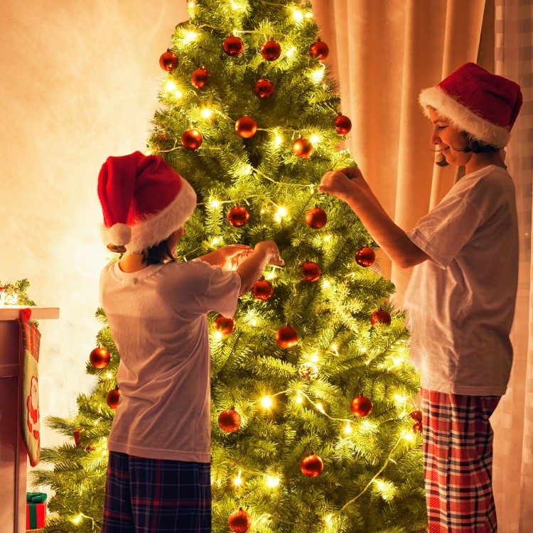 Children decorating a 9 ft Premium Artificial Christmas Tree with metal stand, featuring bright lights and ornaments.