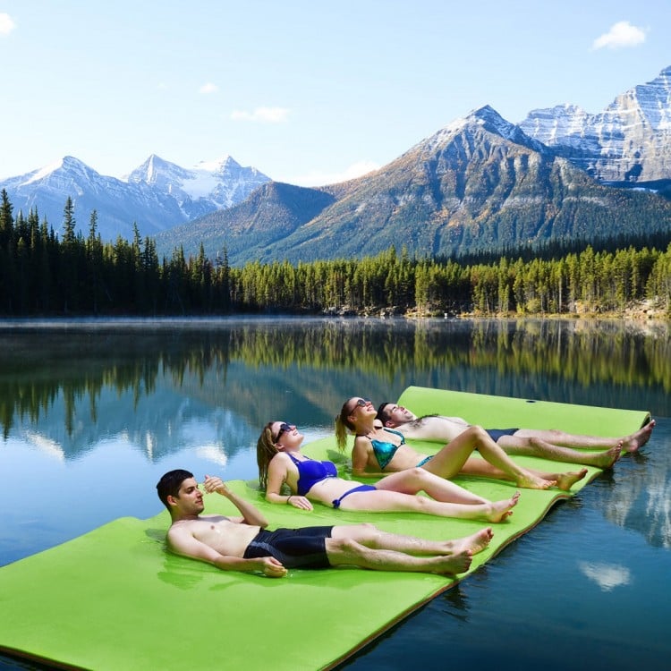 Floating water pad in green, 12’ x 6’, made of durable XPE foam, perfect for relaxing on lakes or beaches with friends.