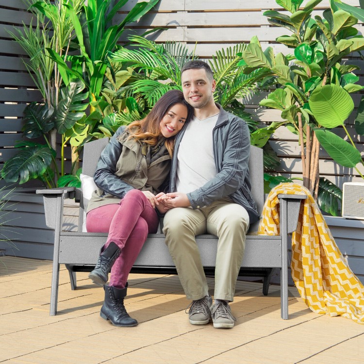 Gray HDPE patio Adirondack chair with two people seated, showcasing ergonomic design and wide armrests for outdoor.