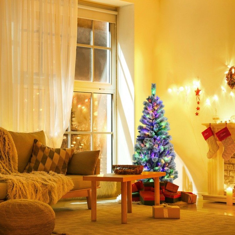 5 feet pre-lit Christmas tree with snow flocked branches and 140 LED lights, creating a festive atmosphere in a cozy.