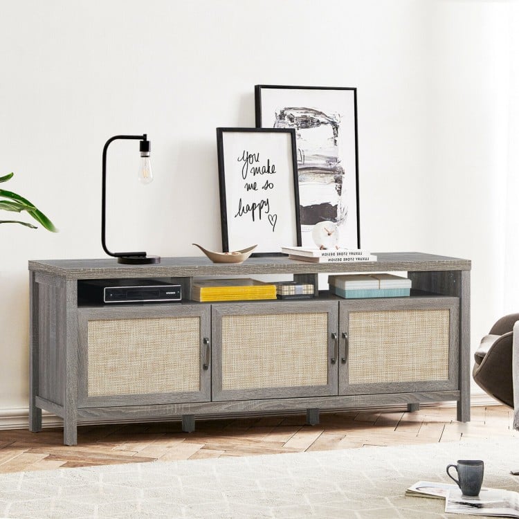Gray TV stand with three cabinets and open shelf, designed for TVs up to 65 inches, ideal for storage and display.