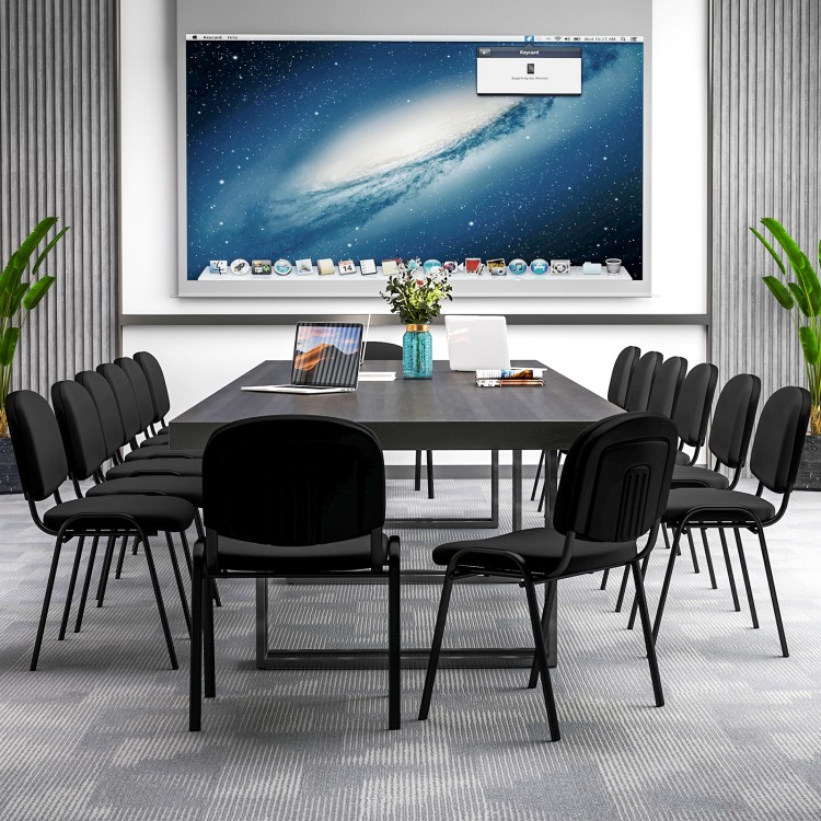 Black office chairs with padded cushions and metal frames arranged around a conference table for meetings.