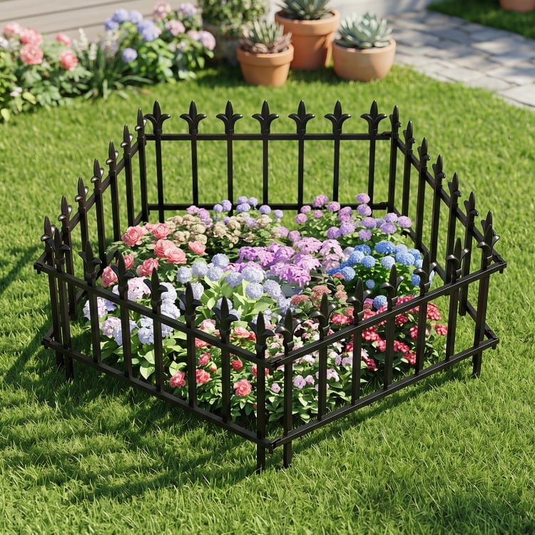 Decorative metal garden fence with fleur-de-lis finials, ideal for protecting flower beds and enhancing outdoor aesthetics.