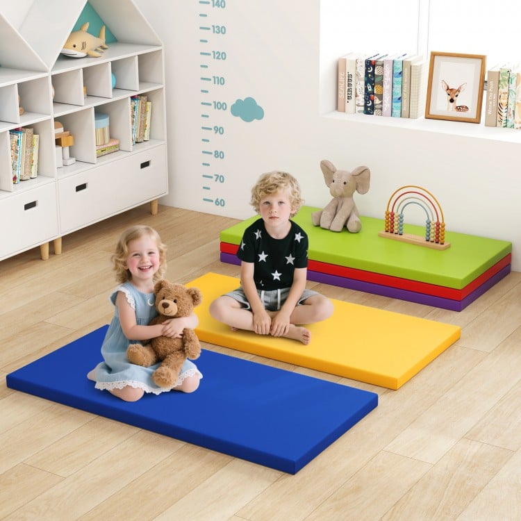 Colorful toddler nap mats in blue, yellow, and green, featuring a stackable design for easy storage and travel.