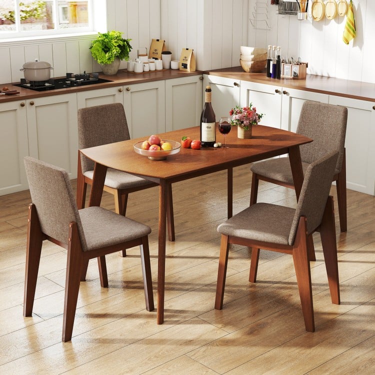 Light brown 5-piece kitchen table set with upholstered chairs, featuring padded seats and a sturdy rubber wood frame.