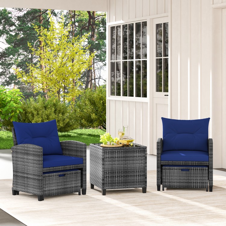 Two navy cushioned chairs and a square glass-top table in a patio setting, perfect for outdoor relaxation.