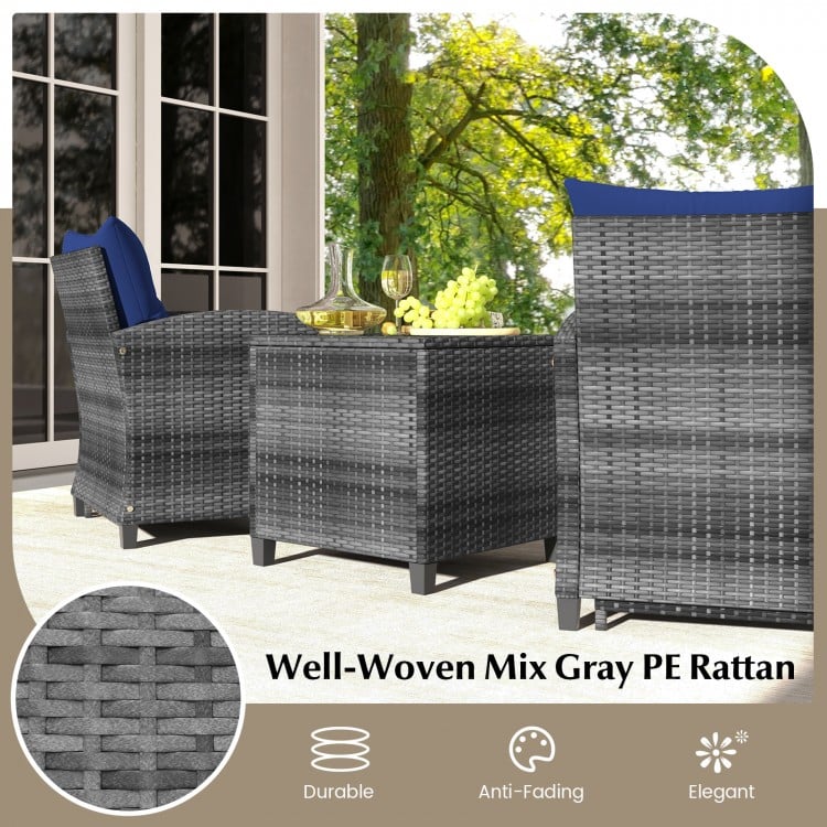 Mix gray PE rattan patio furniture set with navy cushions, including two ottomans and a tempered glass coffee table.