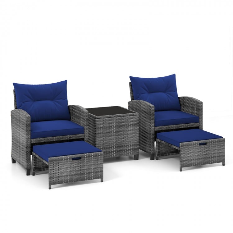 5-piece patio rattan furniture set with navy cushions, including 2 chairs, 2 ottomans, and a tempered glass coffee.