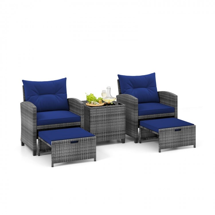 Two navy cushioned chairs with ergonomic design in a gray rattan patio set, ideal for backyard or balcony relaxation.