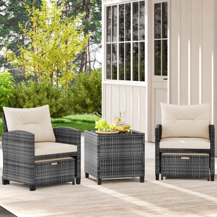 Two comfortable patio chairs with soft cushions and a square glass-top table, perfect for outdoor relaxation.