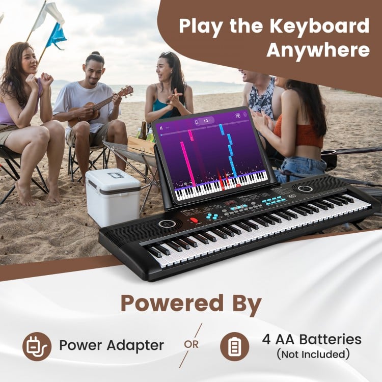 61-key portable digital keyboard piano in black, perfect for beginners, shown in a beach setting with friends.