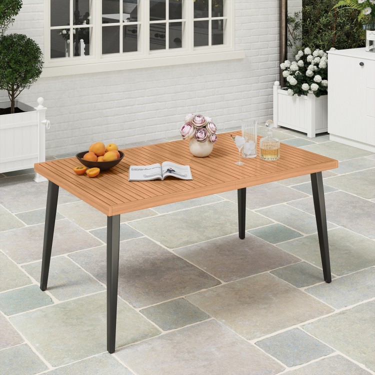 Acacia wood dining table with tapered metal legs, designed for six, featuring an umbrella hole for outdoor gatherings.