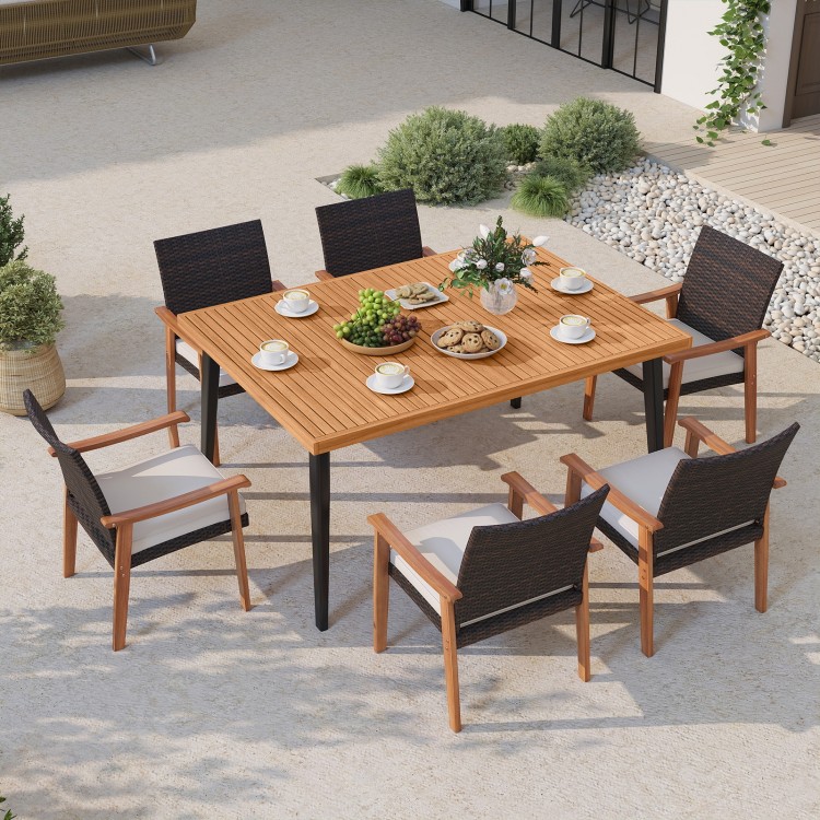 Outdoor dining table with acacia wood top and metal legs, seating six, featuring an umbrella hole for versatile use.