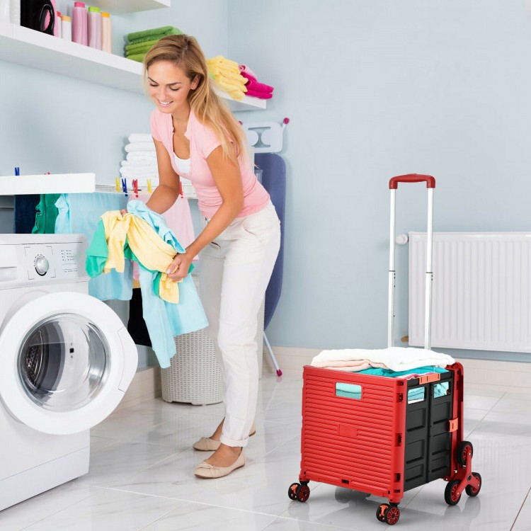 Foldable utility cart in red with tri-wheels, ideal for shopping and transporting items, shown in use by a woman.