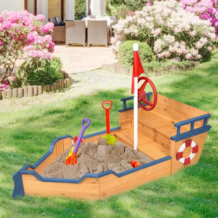 Wooden pirate boat sandbox for kids with benches, flag, and storage space, perfect for imaginative outdoor play.