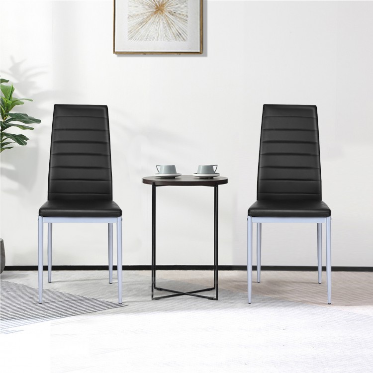 Two elegant black PVC leather dining side chairs with painted steel legs, perfect for modern dining spaces.