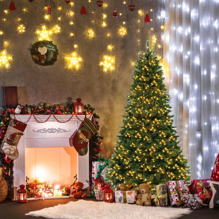 Hinged 6 ft Christmas tree with warm white LED lights and PVC branch tips, perfect for festive home decoration.