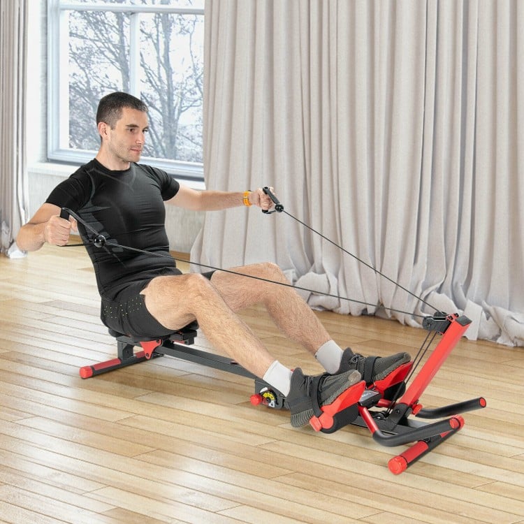 Folding rowing machine in use, showcasing adjustable handrail and control panel for effective home gym workouts.