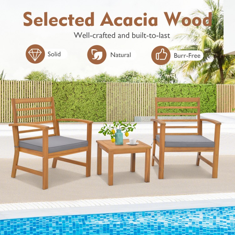 Outdoor furniture set featuring two acacia wood chairs and a side table, with gray soft seat cushions for poolside.