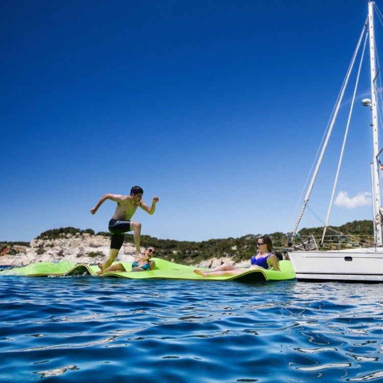Floating water pad in vibrant green, made of durable XPE foam, perfect for fun and relaxation on lakes and beaches.