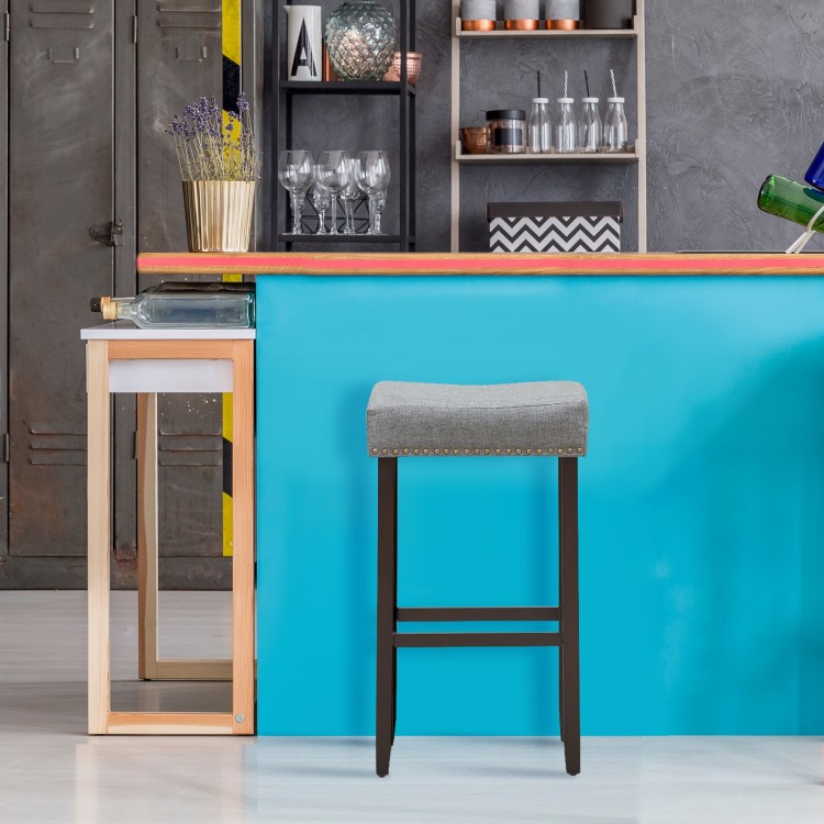 Gray nailhead saddle bar stool with solid rubberwood legs, 29-inch height, perfect for home or bar use.