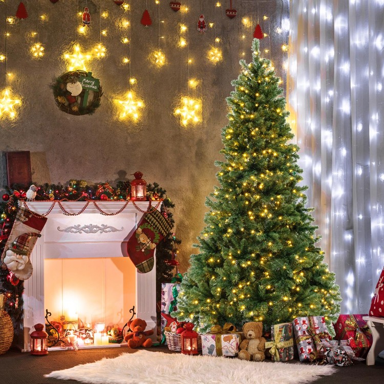 7 ft hinged Christmas tree with PVC branch tips and warm white LED lights, beautifully decorated for the holiday season.