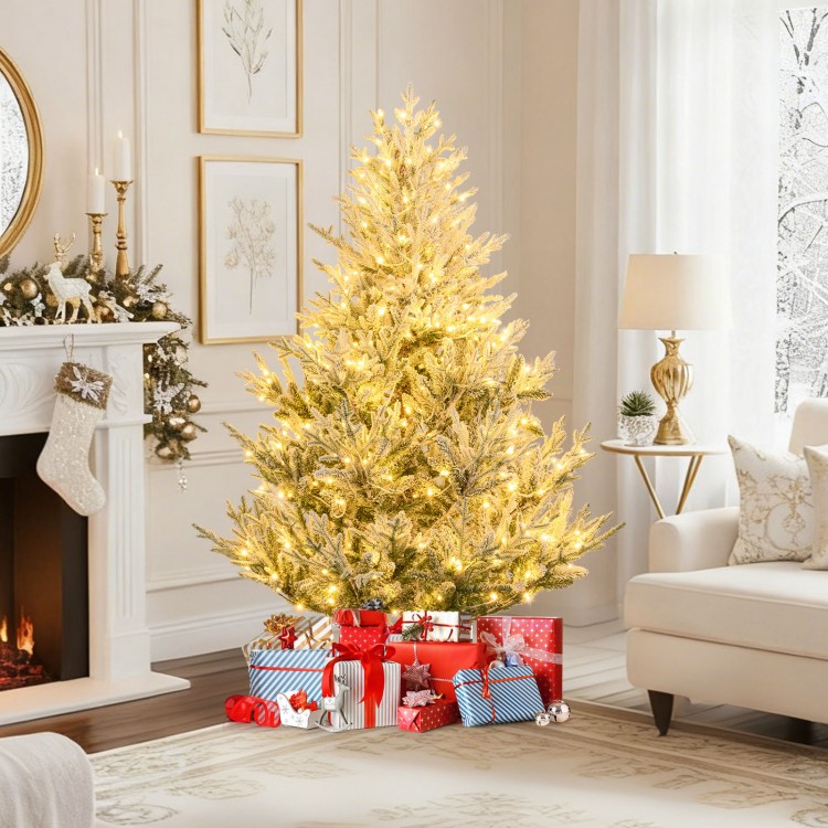 6-foot pre-lit artificial Christmas tree with snow flocking, warm white LED lights, and presents underneath for festive.