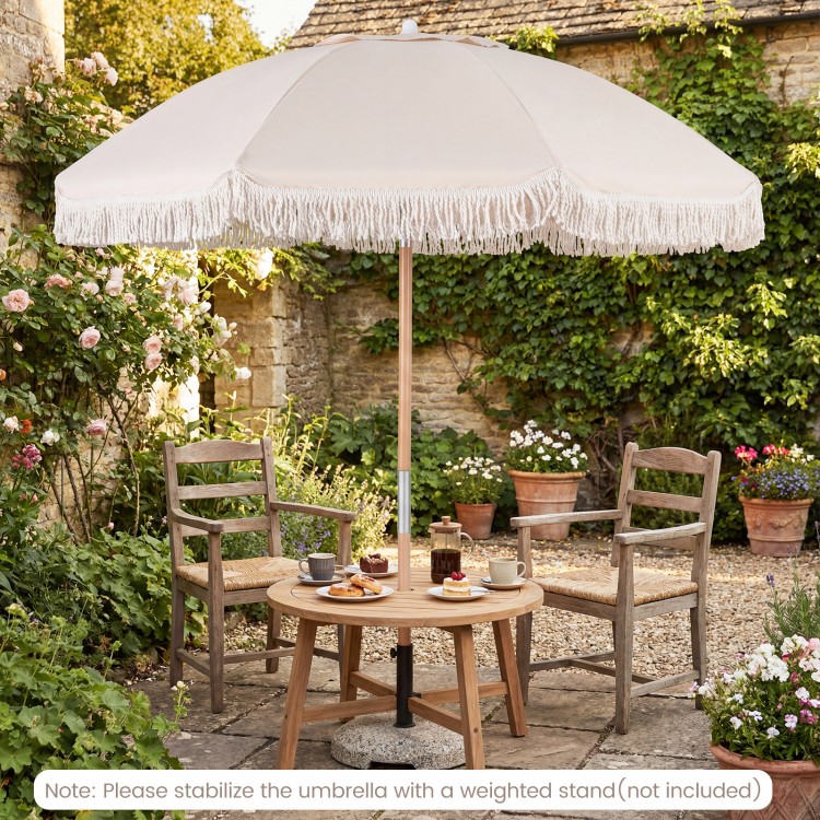 6 feet white patio umbrella with fringe, featuring a wood pole and push button tilt for adjustable shade in a garden.