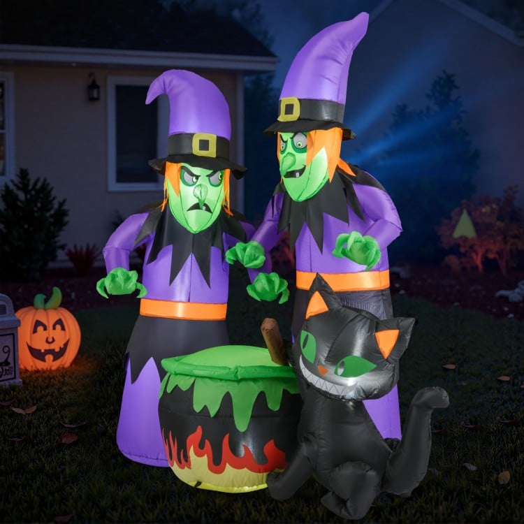 6 ft inflatable black cat beside witches and cauldron, designed for vibrant Halloween yard decorations.