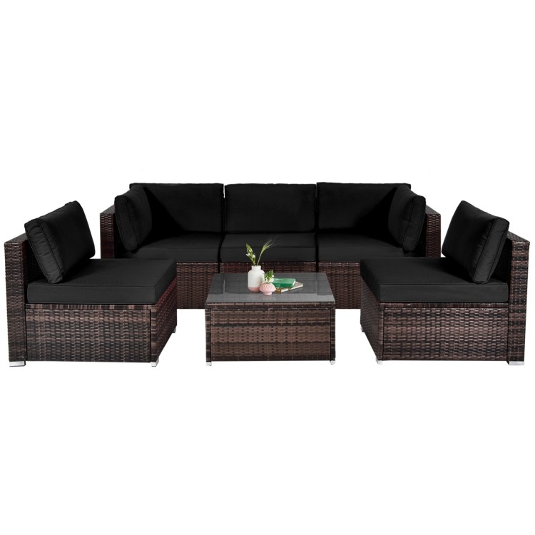 6-piece patio rattan furniture set with black cushions and glass coffee table, perfect for outdoor relaxation.